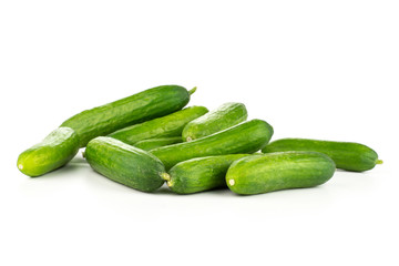 Fresh green mini cucumbers heap isolated on white background.