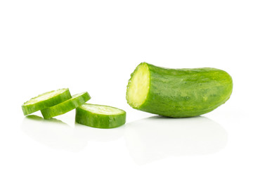 One fresh green mini cucumber half with three slices isolated on white background.