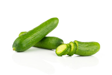 Two fresh green mini cucumbers and sliced half with three slices isolated on white background.