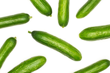 Fresh mini cucumbers flatlay isolated on white background.