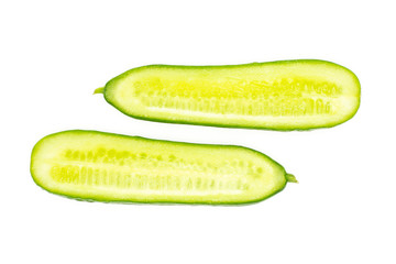 Two fresh mini cucumbers section halves flatlay isolated on white background.