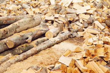 Stacks of firewood in the sawmill. Pile of firewood. Firewood background