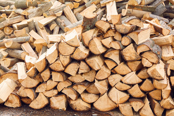 Stacks of firewood in the sawmill. Pile of firewood. Firewood background