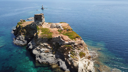 Aerial drone bird's eye view of iconic old castle in port of Andros island chora, Cyclades, Greece