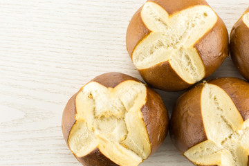 Bavarian bread buns top view on grey wood background fresh baked loaves.
