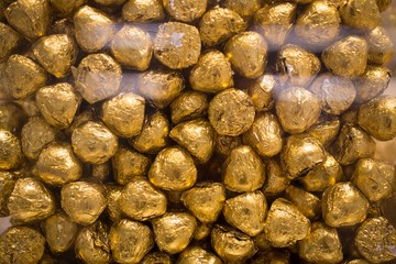 Chocolate candies in gold foil close-up