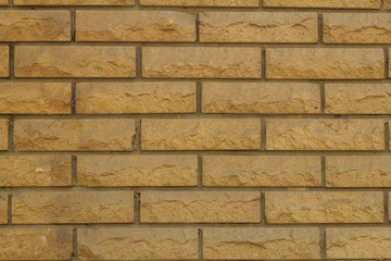 Background of a wall made of bricks made of sandstone texture
