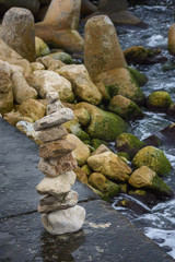 Stone pyramid on the beach. Pile of rocks on a mole. Сtability, zen, harmony concept
