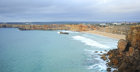 Obraz premium Surfers in Tonel beach of Sagres. Bathed by the Atlantic Ocean is one of the most visited by European tourism. Algarve, south of Portugal.