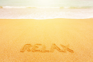 Beautiful sunny beach by the blue sea. Inscription 