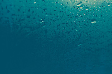 misted glass. Water on the car glass. beautiful desktop, blue, background.