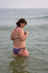 A woman is fixing her bikini