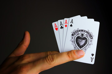 Playing cards of aces in the colors of spikes, carts, hearts and crosses