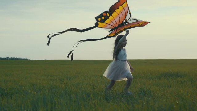 girl running around with a kite on the field. Freedom concept.