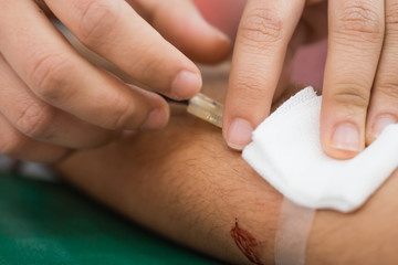 Obraz na płótnie Canvas Health and Medical concept. Closeup Hands nurse are using needle to pierce vein bleeding Preparation for blood test. Blood donation occurs when person voluntarily has blood drawn used for transfusions