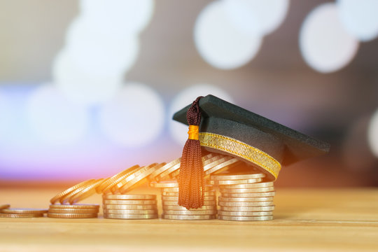 Education Graduate study scholaship concept : Congratulations graduates on top stacks of coins on wood table color background. Ideas Educational for successs study or business have to use many Money