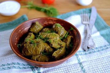 Dolma / Sarma, a traditional Armenian dish in a clay bowl. Served with natural yogurt and garlic sauce