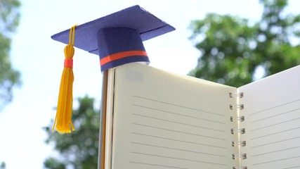 Graduated or Graduation university study abroad international Conceptual, Congratulations to graduates hat on notebook with pencils for copy space. Studies lead to success in Goal life. Back to School