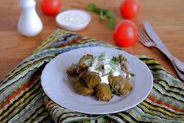 Dolma / Sarma, a traditional Armenian dish, minced meat with rice and spices in grape leaves.Served with natural yogurt and garlic sauce