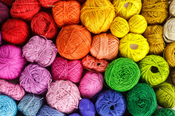 Rainbow-colored yarn balls, viewed from above. - 211274437
