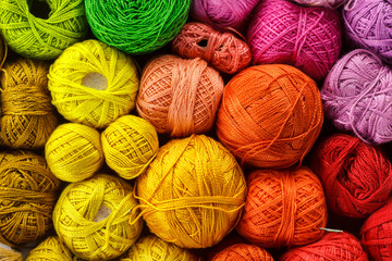 Rainbow-colored yarn balls, viewed from above.