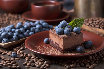 Chocolate cake with blueberries and mint .
