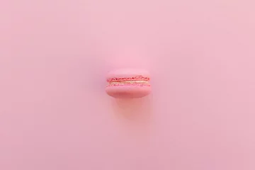 Keuken spatwand met foto tasty pink macaron on trendy pastel pink paper flat lay. space for text. pink macaroons. modern food photography concept. luxury catering. minimalism concept © sonyachny