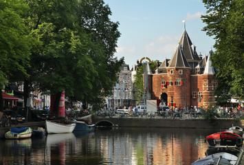 Kloveniersburgwal channel and De Waag - old scales in Amsterdam. Netherlands