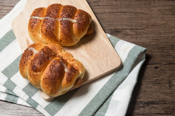 closeup delicious baked sausage bread roll on wooden background