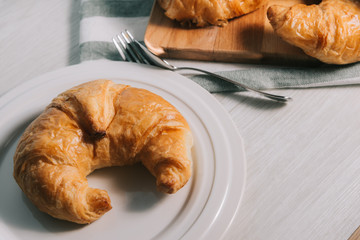 breakfast bakery concept : fresh french croissant on wooden background