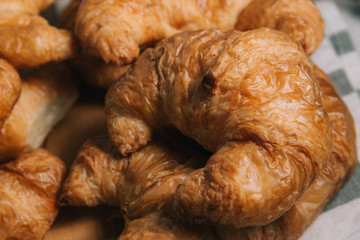 breakfast bakery concept : fresh french croissant on wooden background