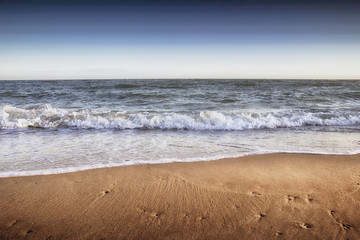 beautiful yellow sandy beach near the blue sea