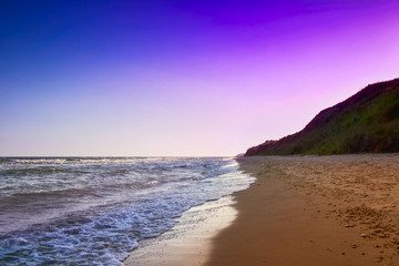 Fototapeta na wymiar yellow sand beach near the blue beautiful sea