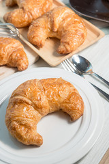 breakfast bakery concept : fresh french croissant on wooden background