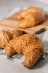 breakfast bakery concept : fresh french croissant on wooden background