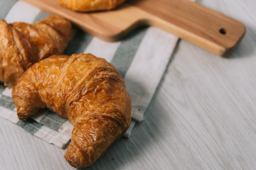 breakfast bakery concept : fresh french croissant on wooden background