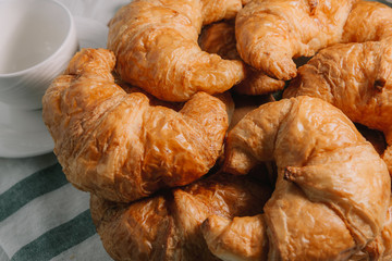 breakfast bakery concept : fresh french croissant on wooden background