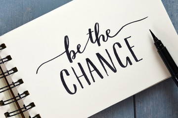 BE THE CHANGE hand-lettered in notebook