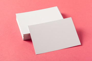 Blank paper pieces  on a colored pink background