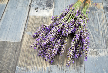 Dried bunch of lavender on a wooden background stock photo images. Bunch of french lavender. Relaxing scented lavender flowers on a wooden background. Provence decoration images