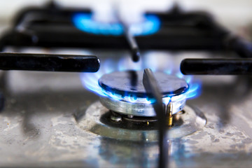 Natural gas burning on kitchen gas stove in the dark. 