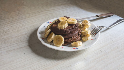 dietetic pancakes with banana on an old countertop
