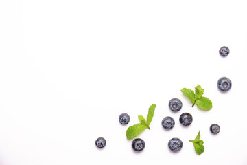 Bunch of fresh organic blueberry berries and mint leaves in seamless pattern, white background. Clean eating concept. Healthy nutritious vegan snack, raw diet. Close up, copy space, top view, flat lay