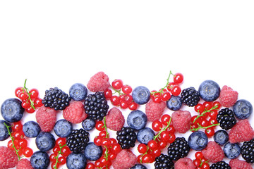 Bunch of mixed berries in harvest pile on white background. Colorful composition with fresh organic strawberry, blueberry, blackberry & redcurrant. Clean eating concept. Close up, copy space, top view