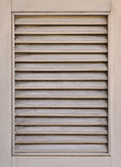 a row of old vintage windows on a street in the city.