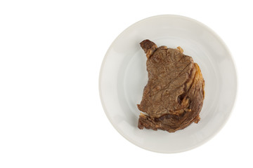 Fried chunk of meat (ripe steak) on a white plate on an isolated background