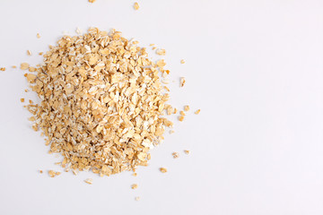A bunch of oat flakes on a light background