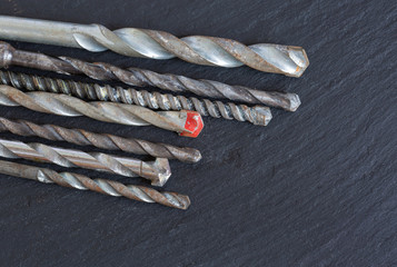 Various old masonry drill bits on slate