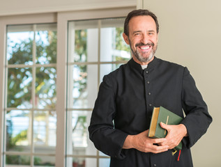 Fototapeta premium Christian priest man with a happy face standing and smiling with a confident smile showing teeth