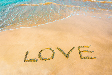 LOVE lettering on the beach with wave,Copy space.
